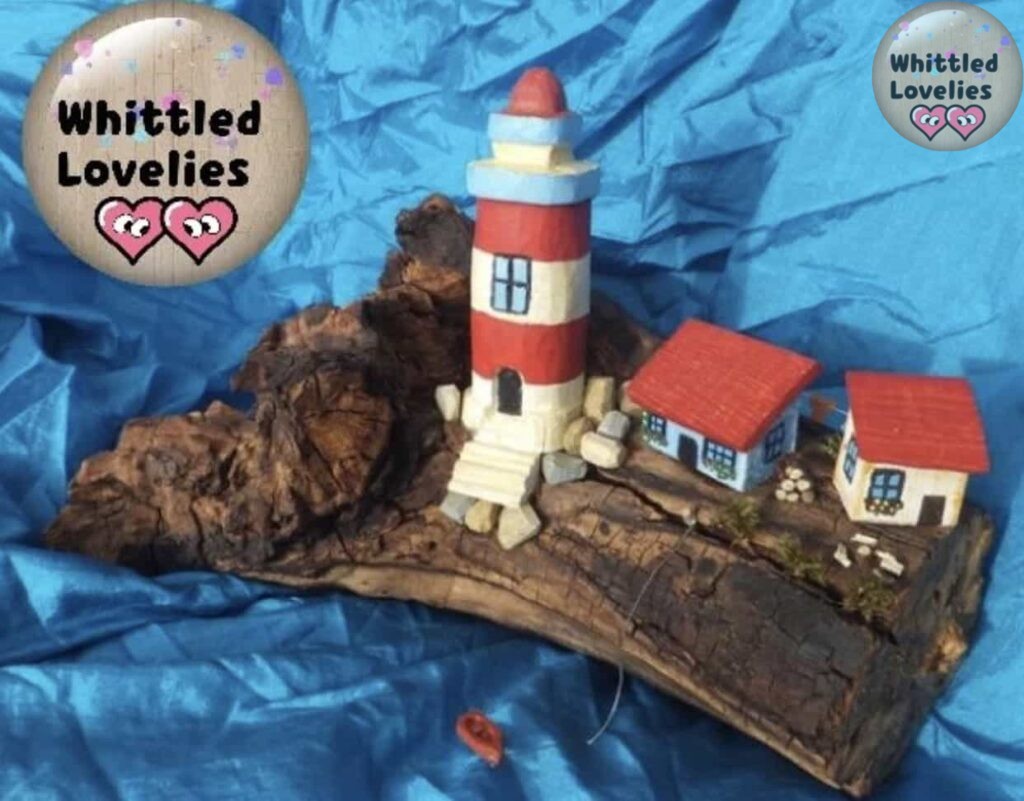 Lighthouse with small village carved on old wood. The lighthouse carving was done with a crescent-shaped blade that is very practical for rounded shapes