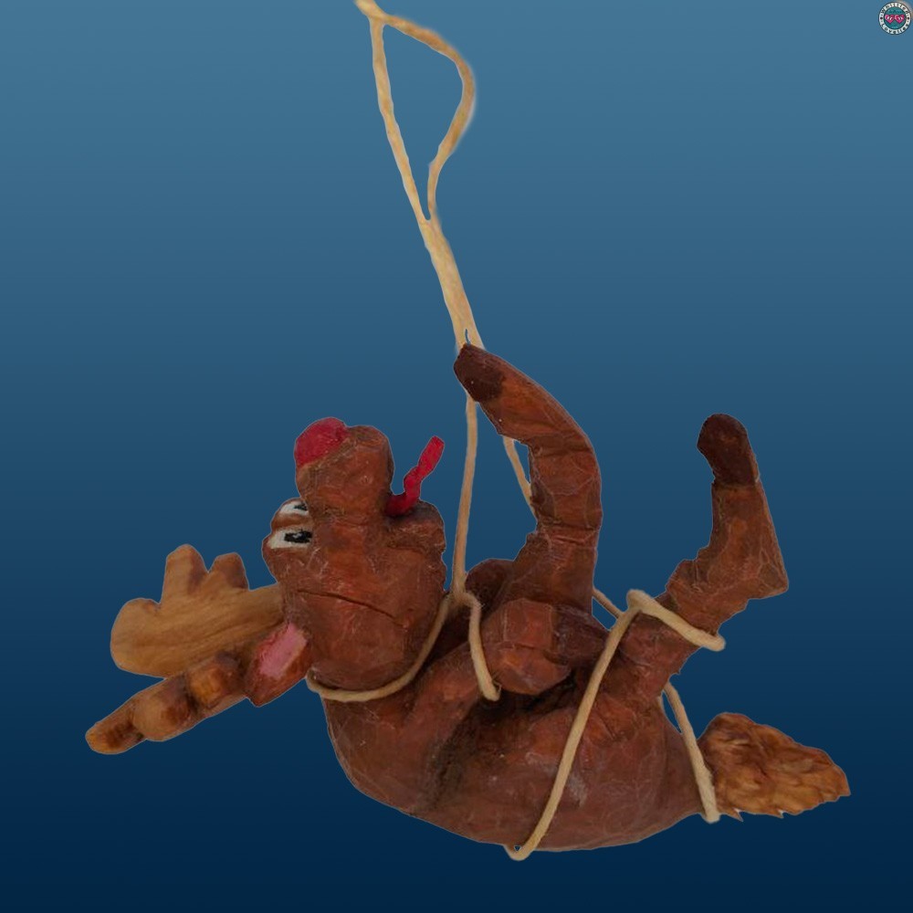 Close-up of Rudolph in the Christmas 2024 diorama: suspended with the sleigh and falling gifts, created with woodcarving.